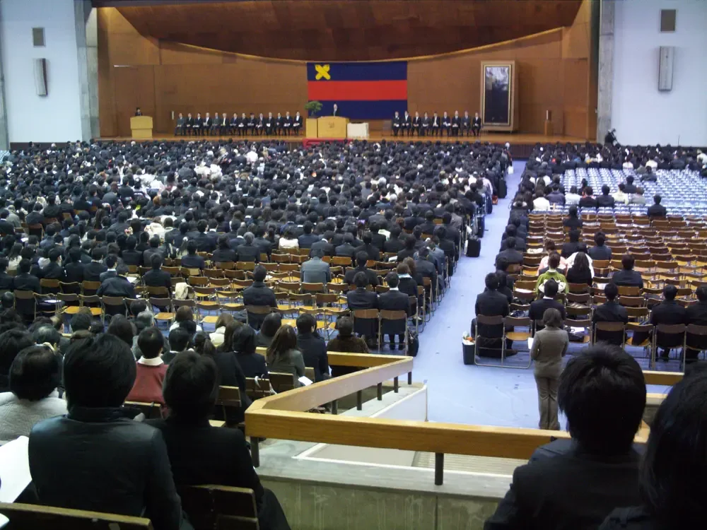 Graduates in academic dress at a formal university commencement ceremony